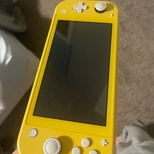 Nintendo switch lite. Used one time since bought in dec 2021. 3 games provided